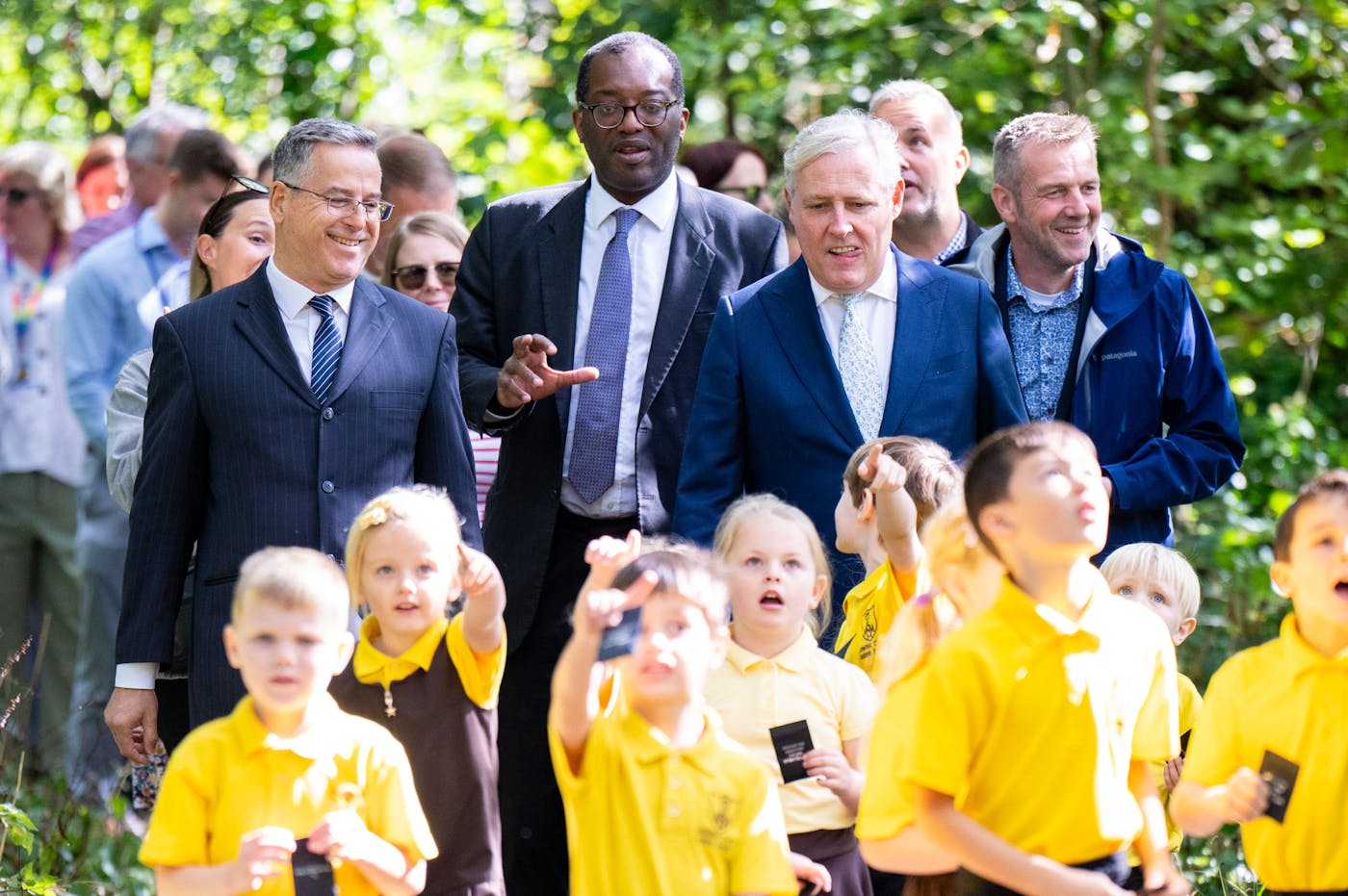 Group of people and children walking on footpath