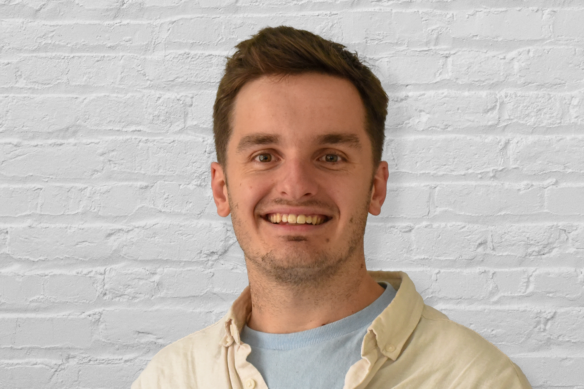 A person in front of a brick wall