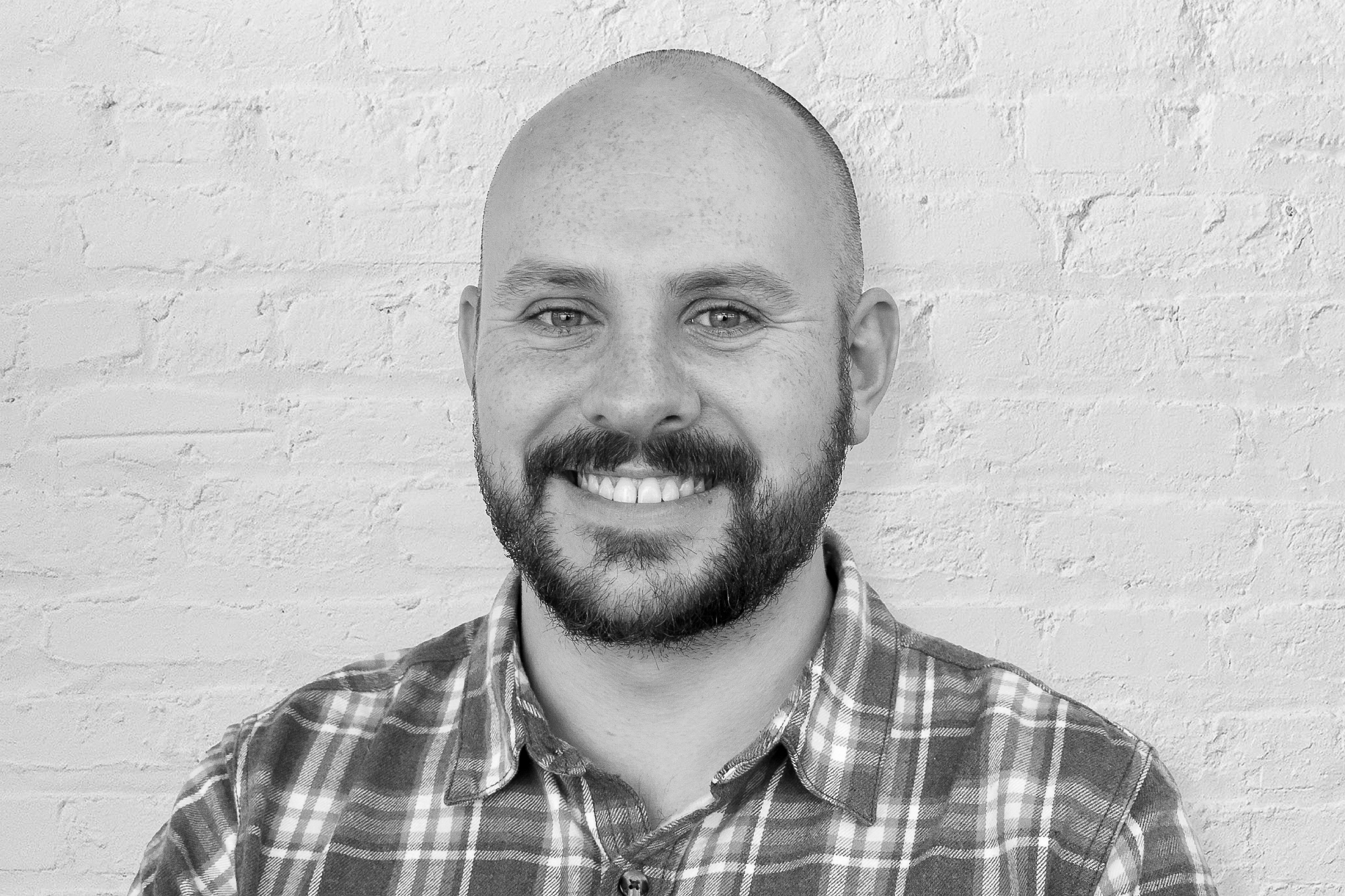 Person in front of brick wall