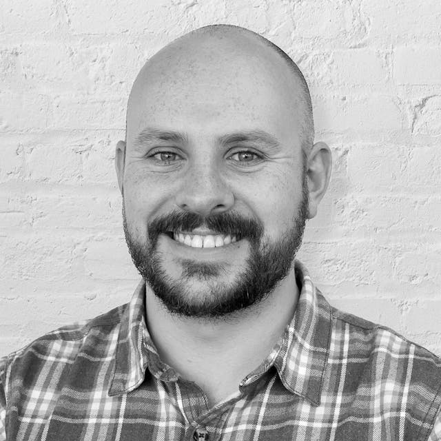 Person in front of brick wall