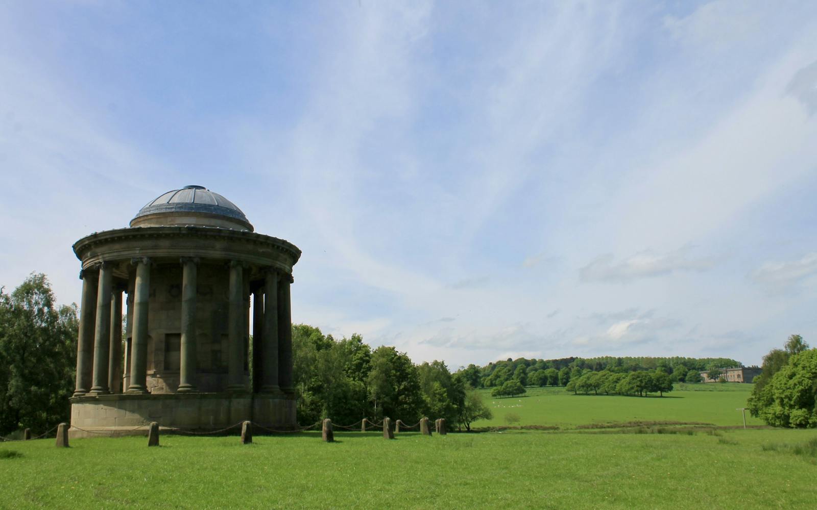 A rotunda with fields in the background
