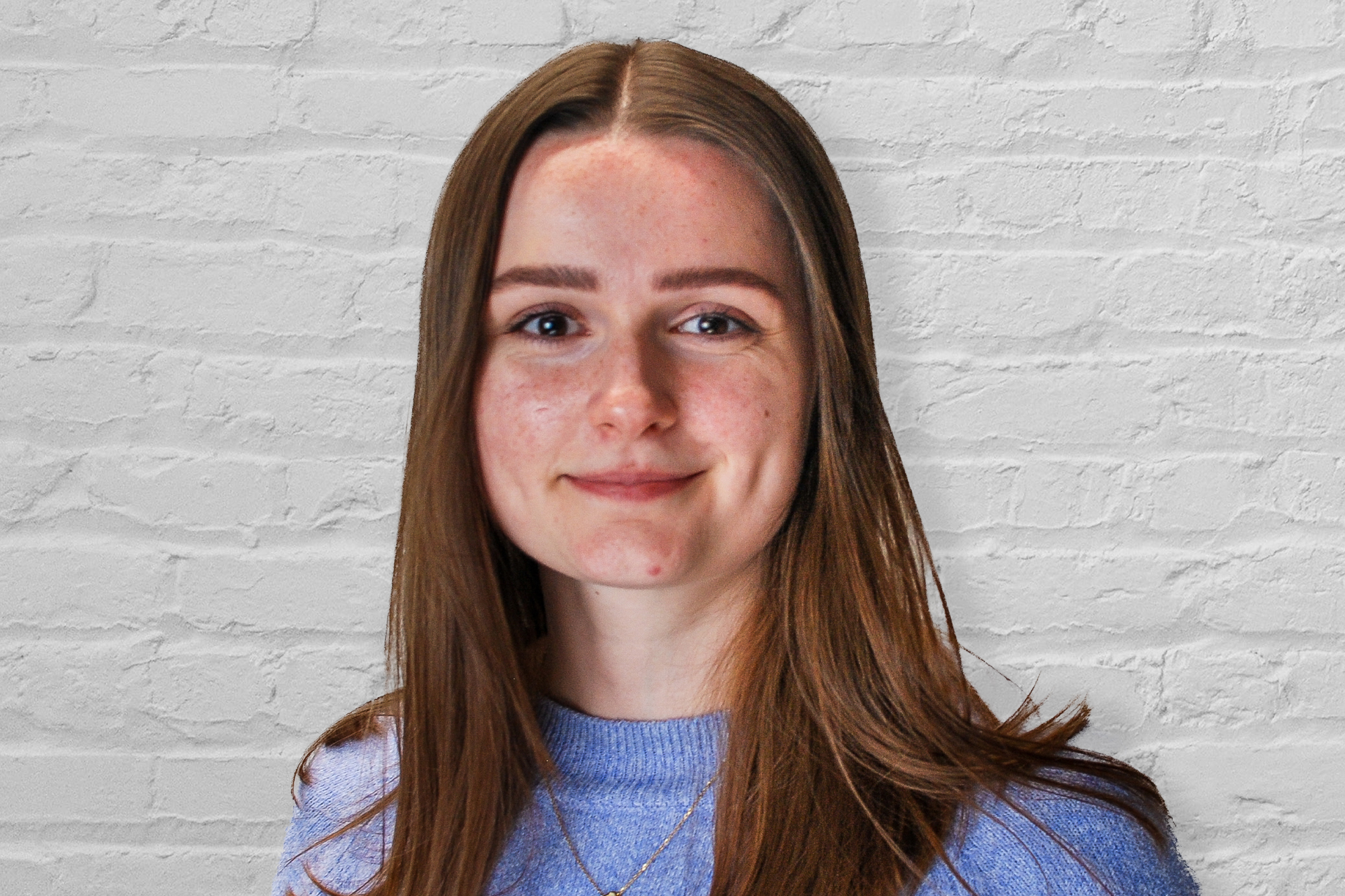 Emily Eales in front of a white brick wall
