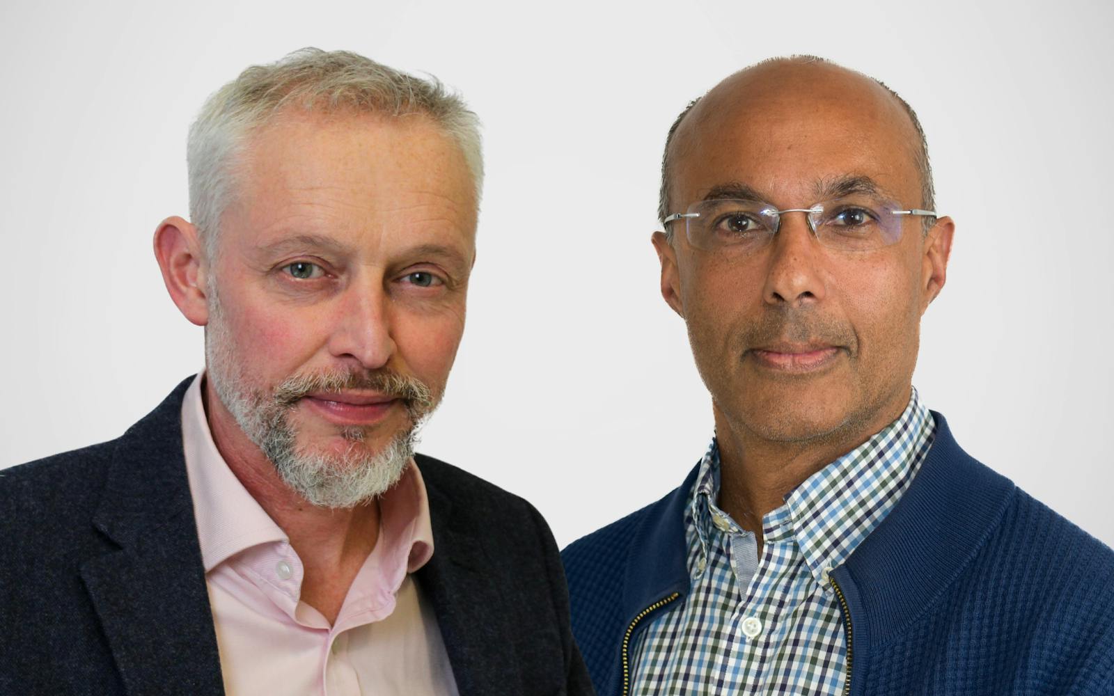 Two men posing for a professional headshot against a plain white background.