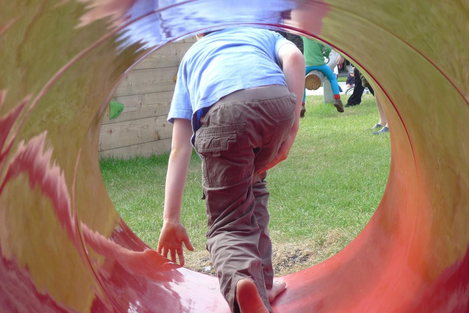 A child playing in a tunnel