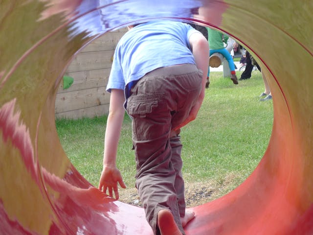 A child playing in a tunnel
