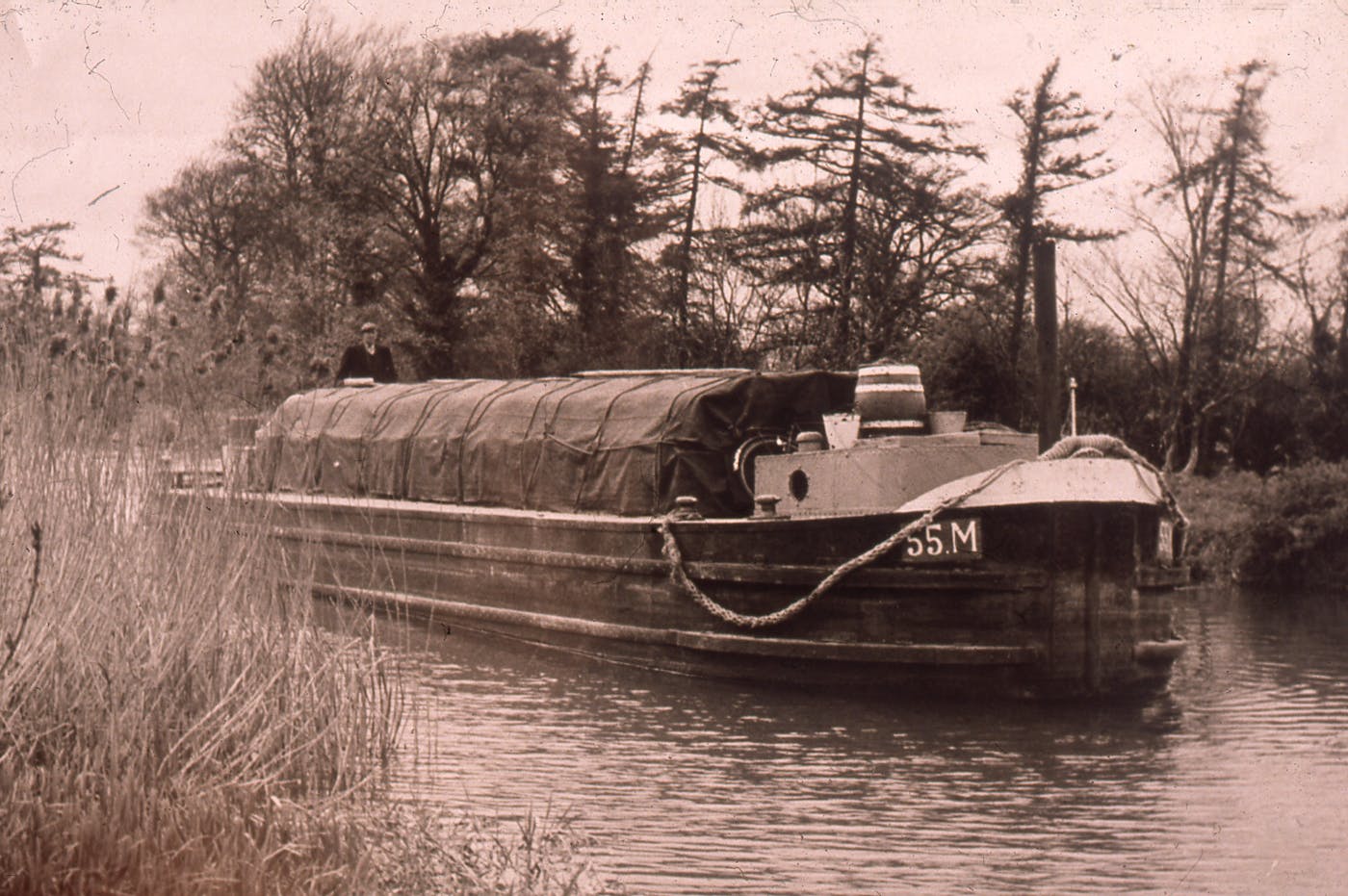 A vintage photo of a boat on a canal