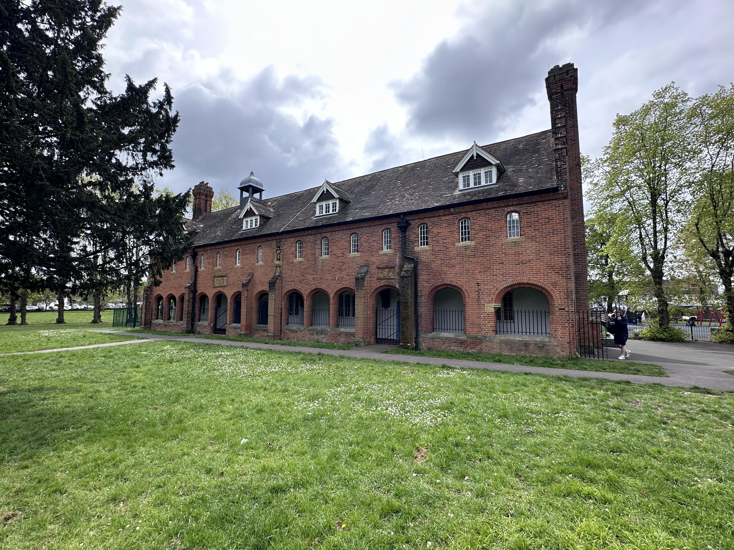 a house in a field surrounded by trees