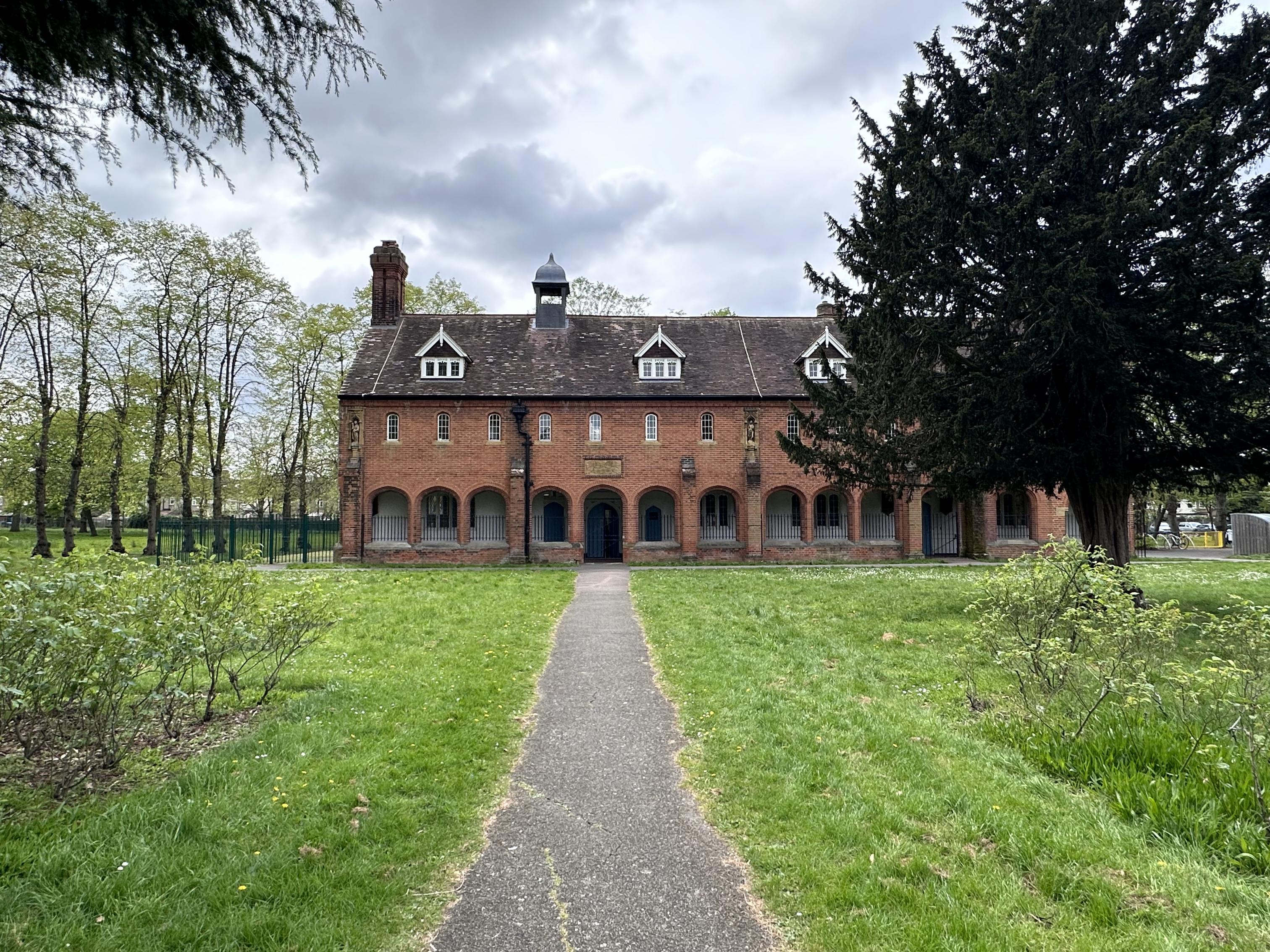 a house in a field surrounded by trees