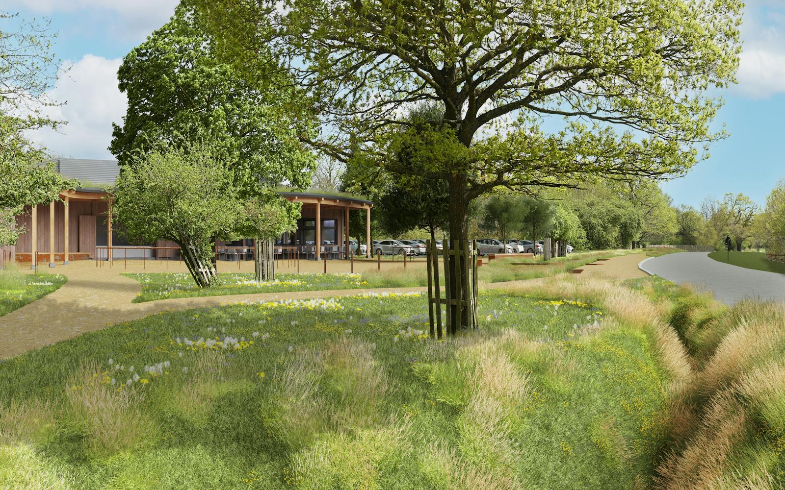 Two similar renderings show a modern, light-brown building with a covered walkway next to a road in a park-like setting. Trees and parked cars surround the building. The top image shows a view from across the road, while the bottom image is a closer view from a slightly different angle on the same side of the road as the building.