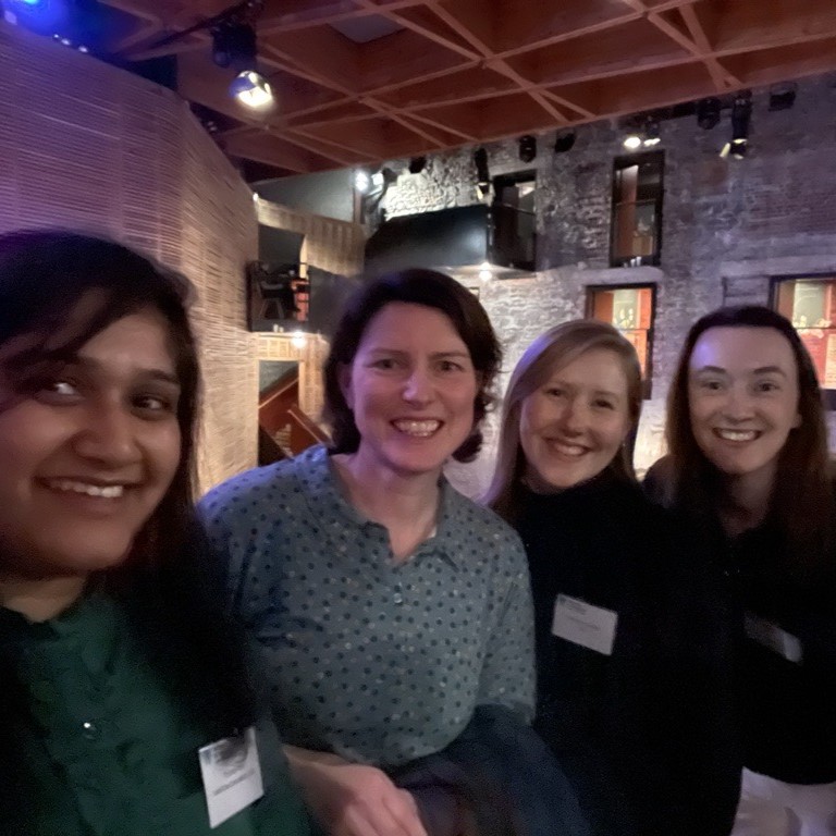a group of women smiling for a photo