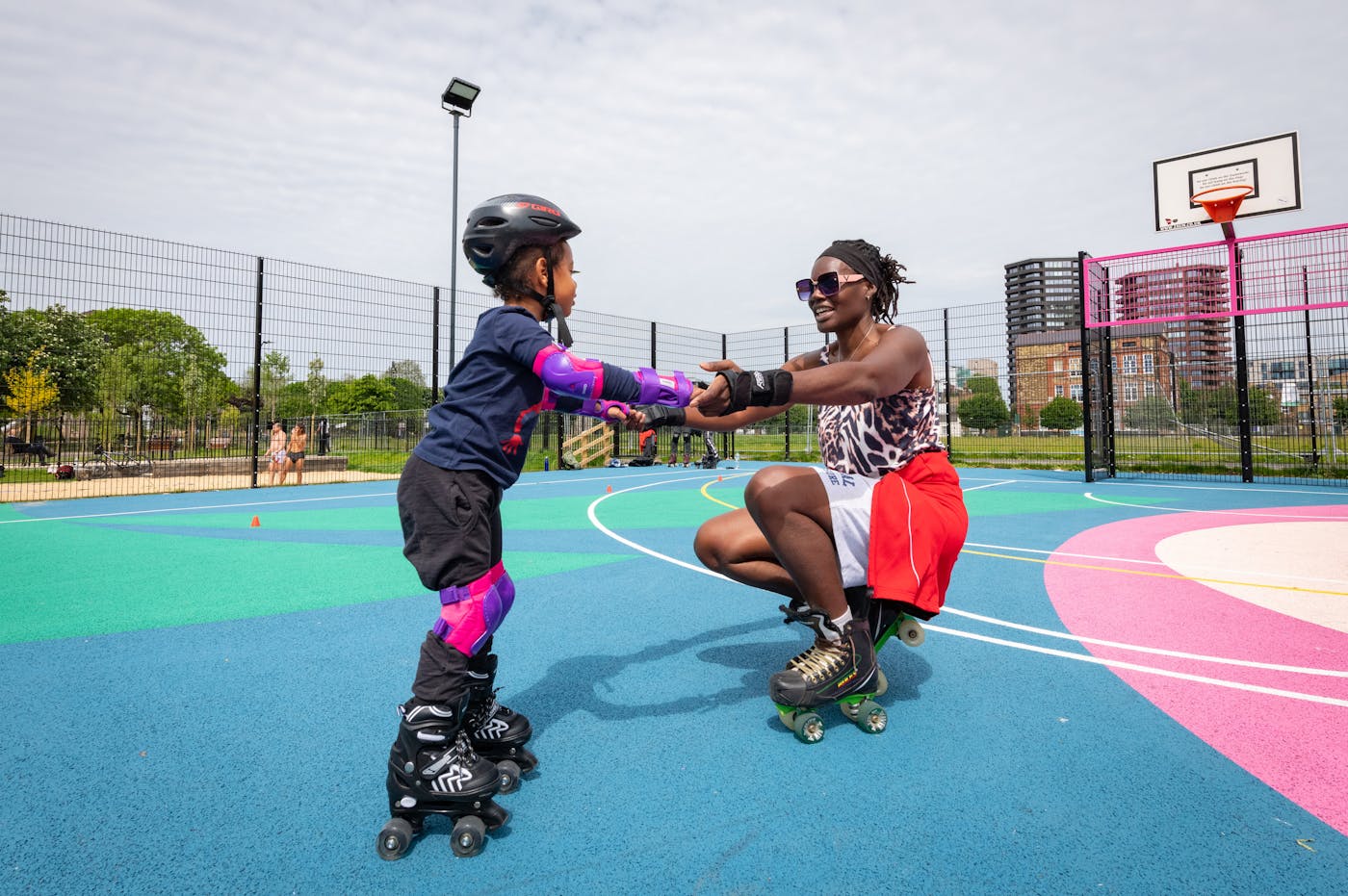 a woman and child on roller skates