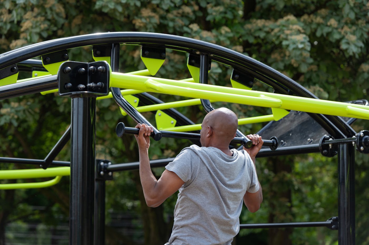 a man lifting weights on a playground