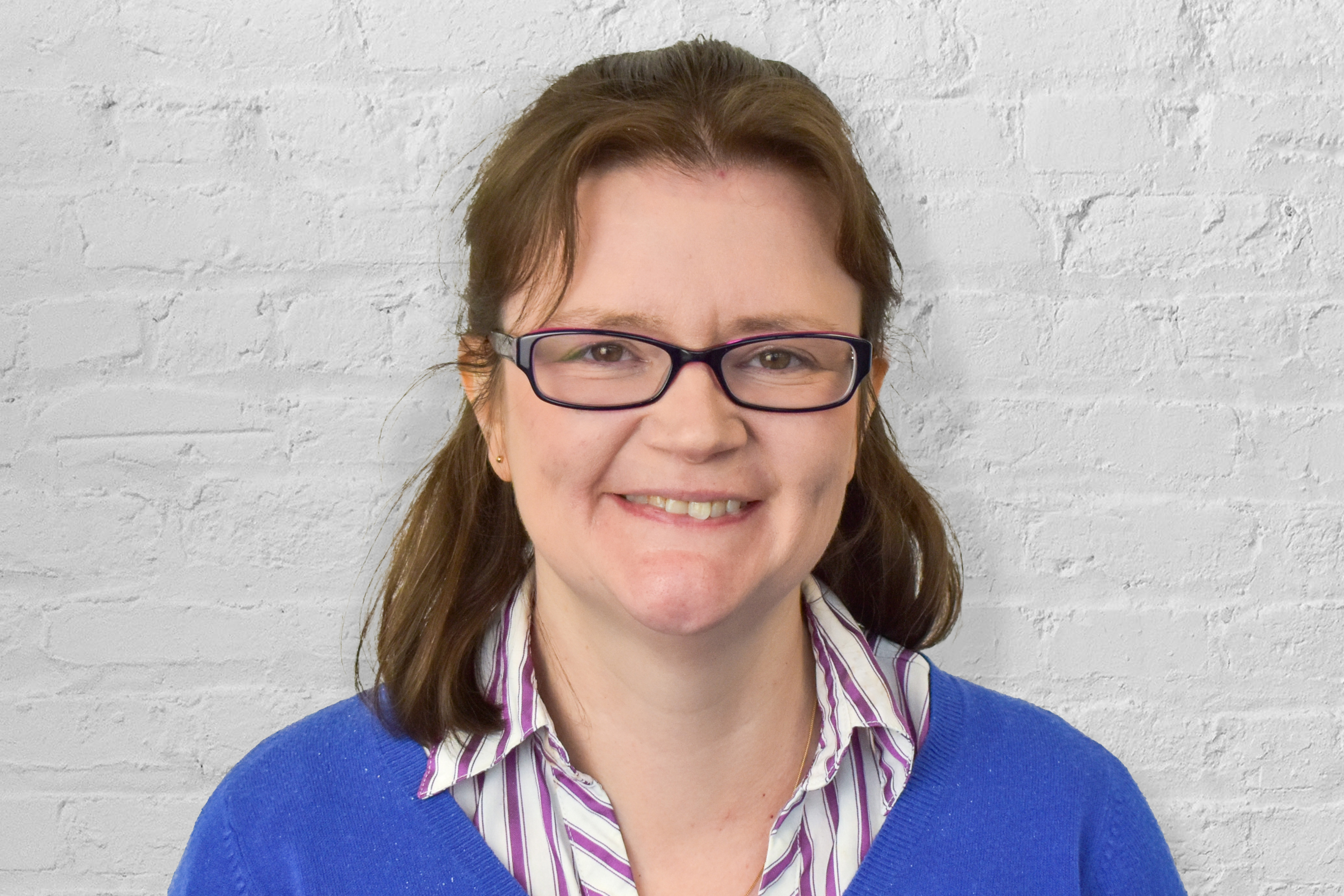 Person in front of brick wall