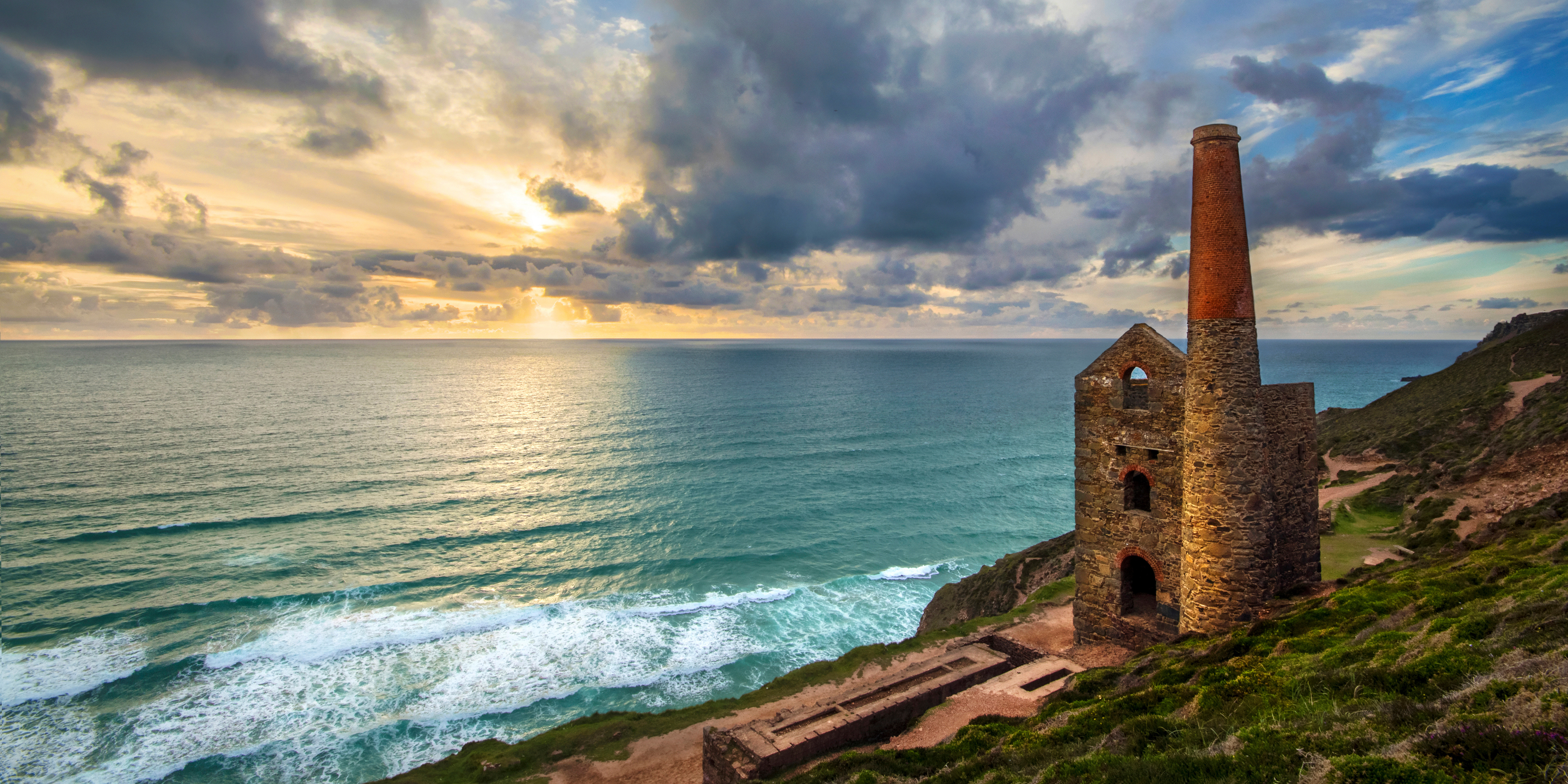 a building on a cliff by the ocean