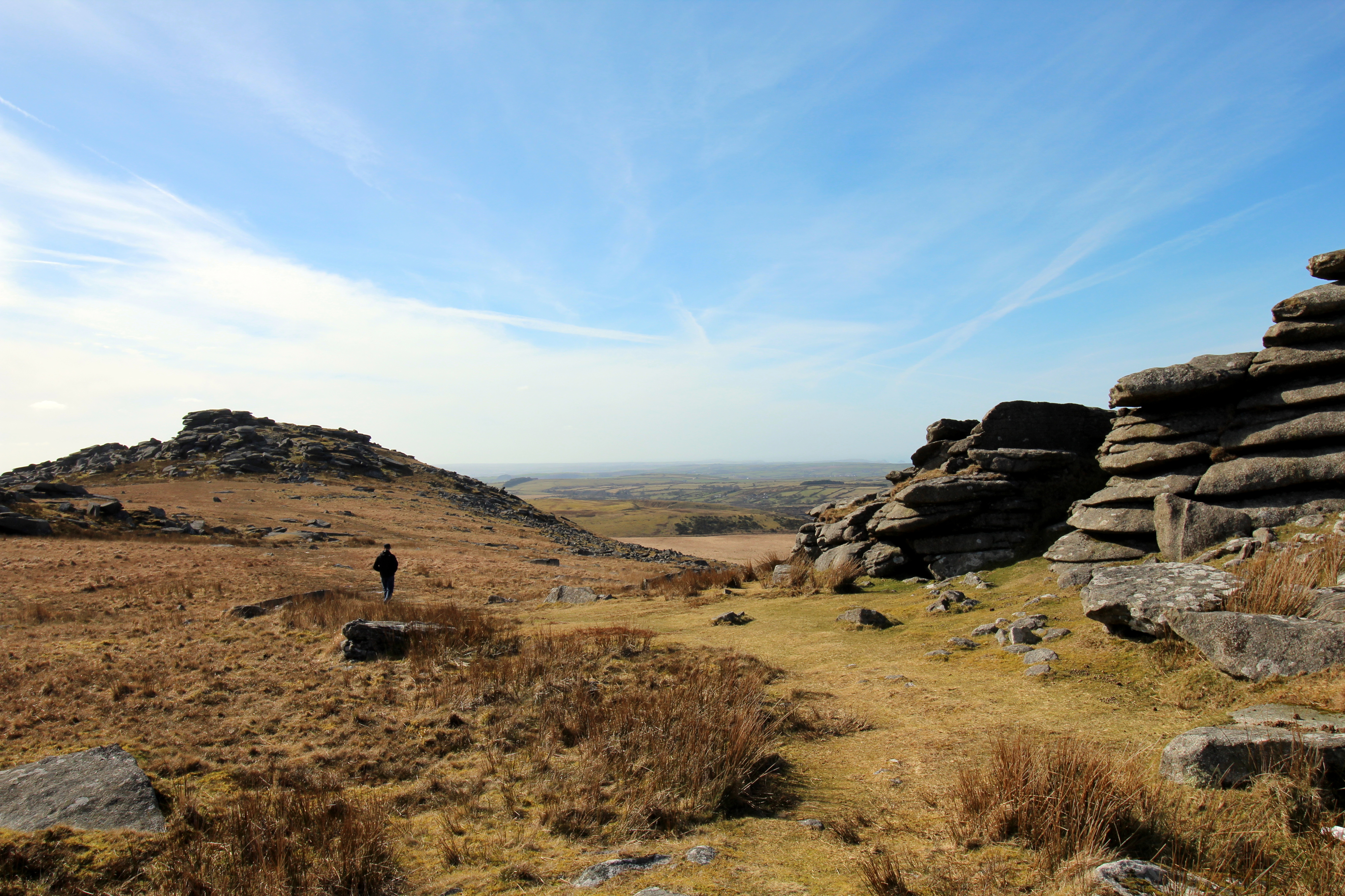 a person walking on a rocky hill