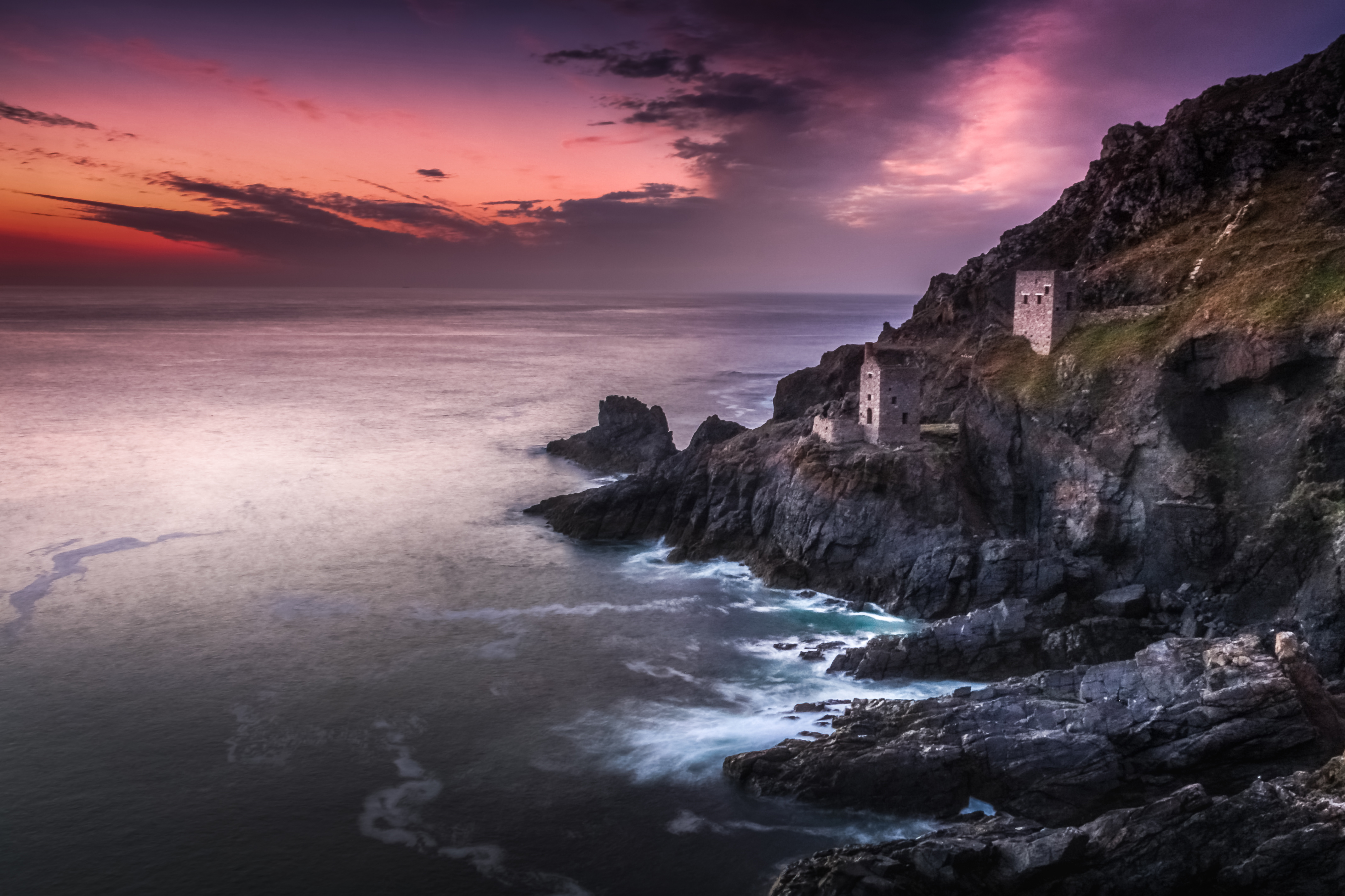 a rocky cliff with buildings on it