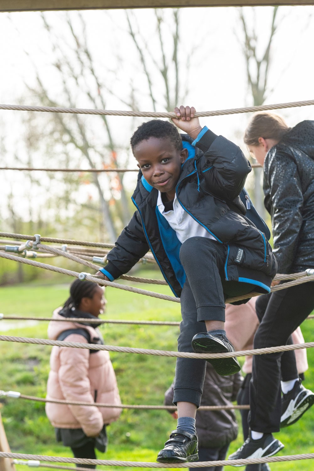 a boy climbing a rope