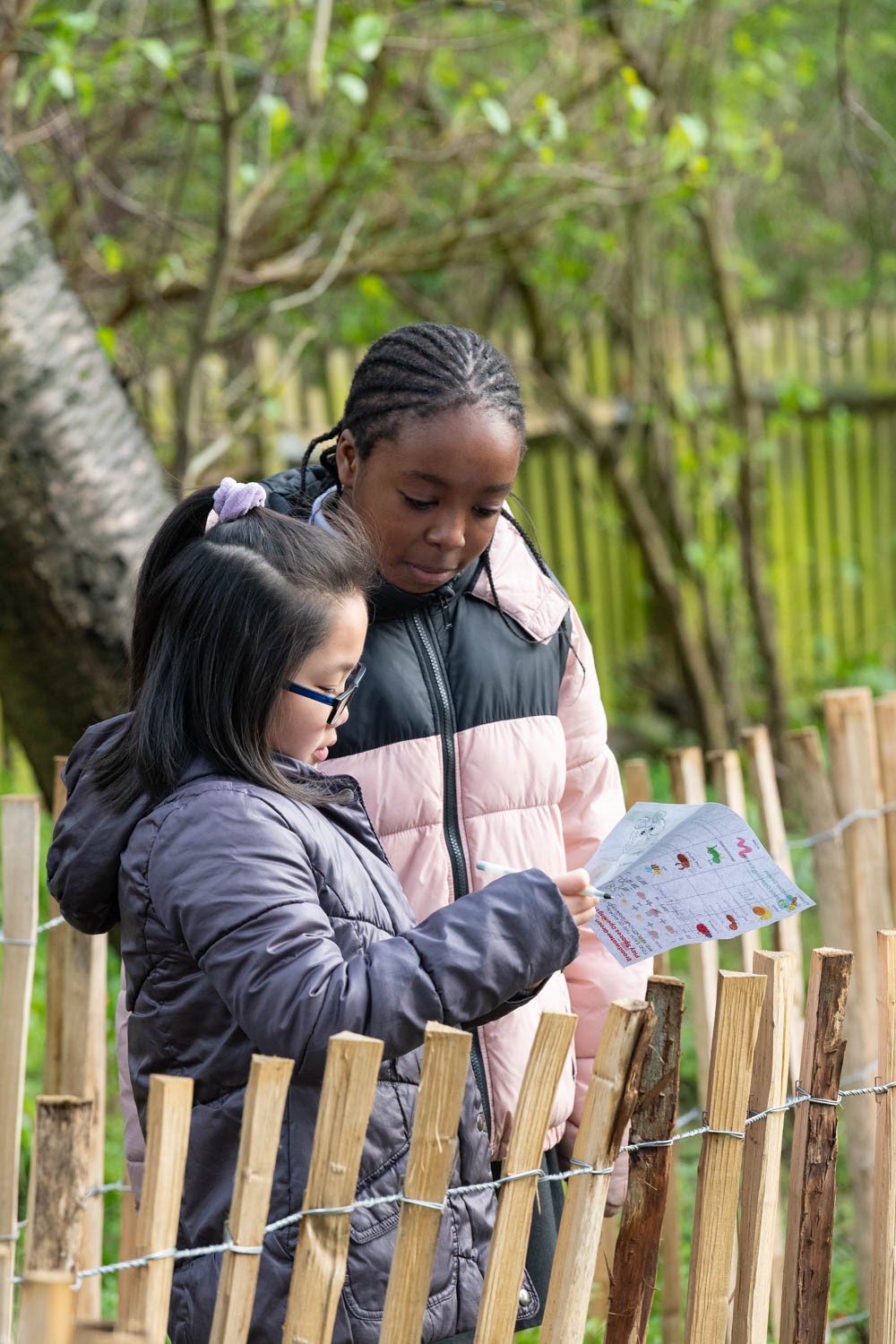 a group of girls looking at a piece of paper