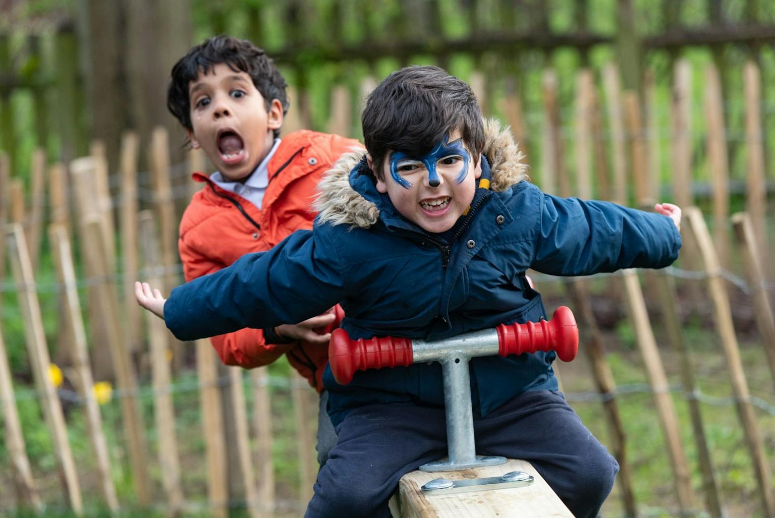 two boys with face paint on a playground