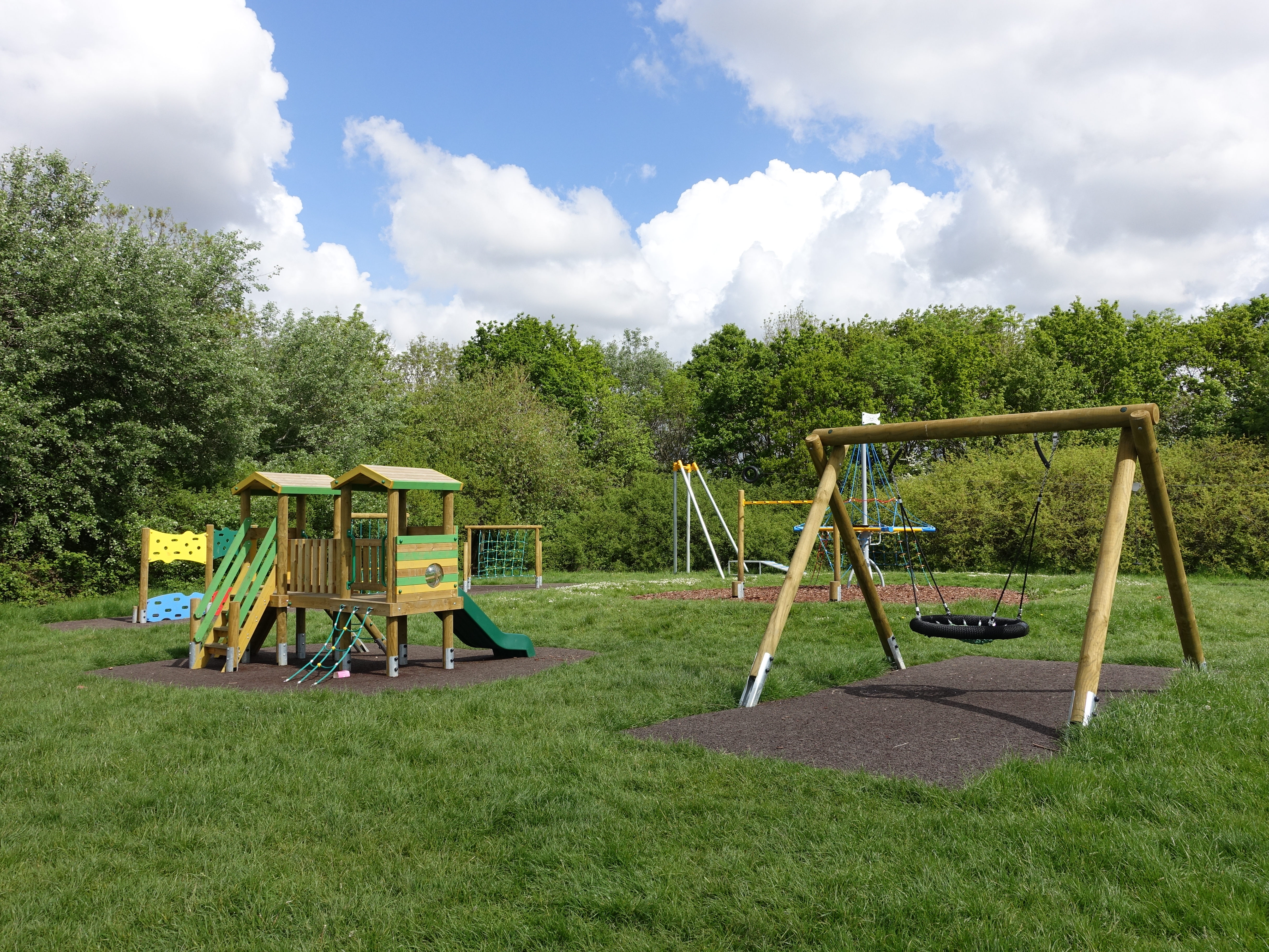 a playground with swings and a play set