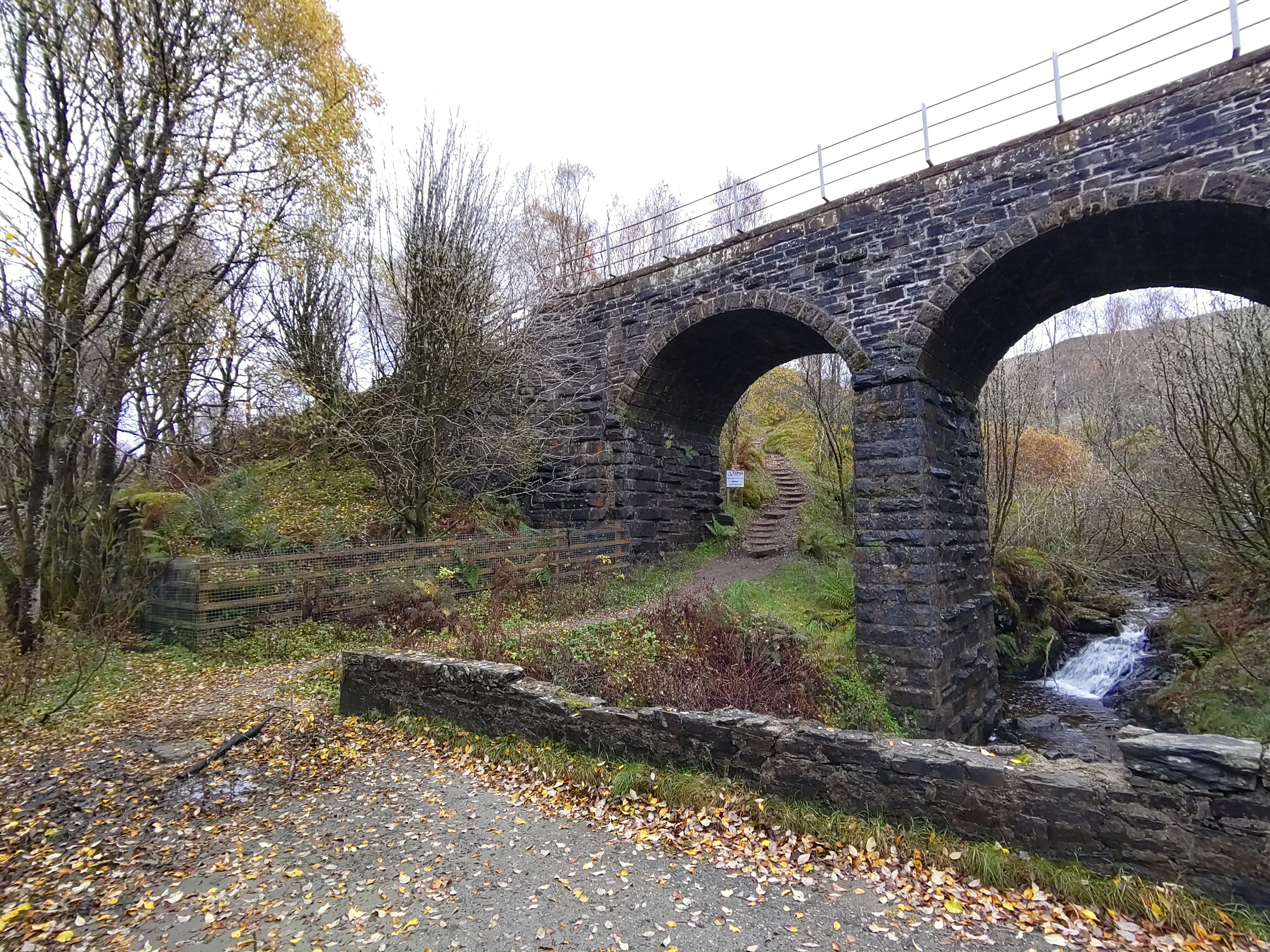 a stone bridge with a bridge over a river