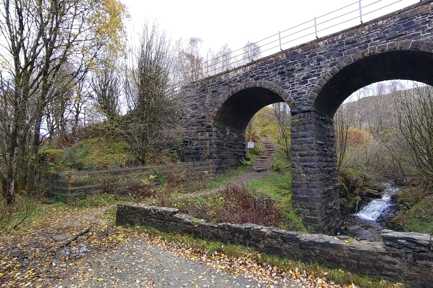 a stone bridge with a bridge over a river