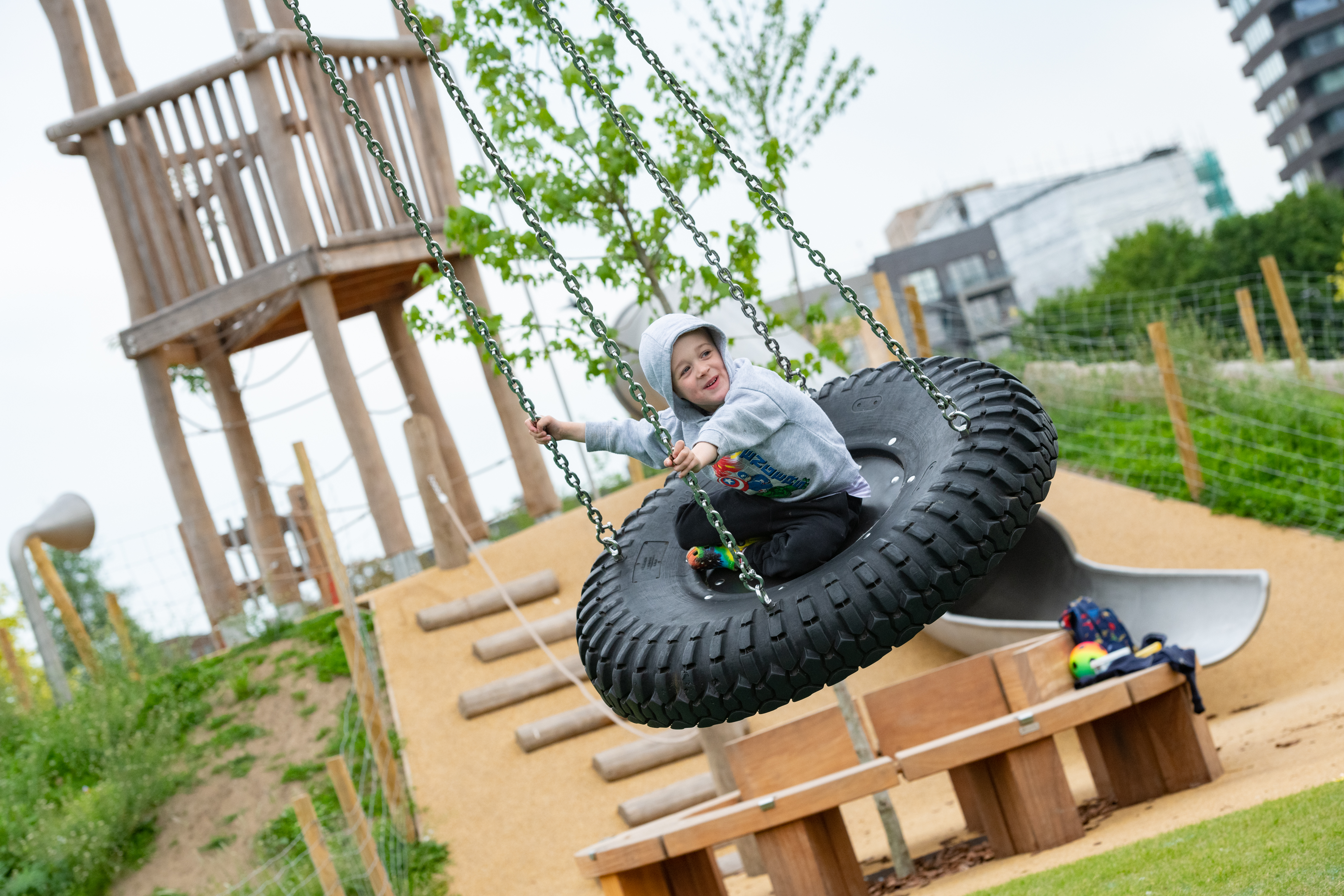 Child playing on tyre swing