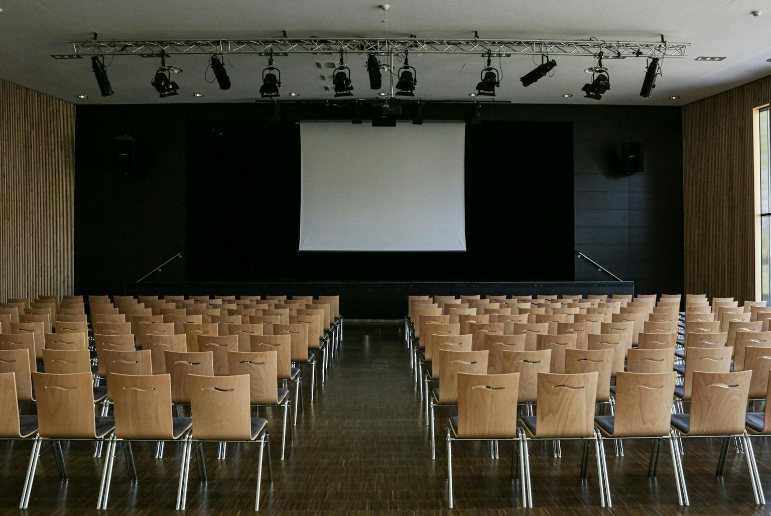a room with chairs and a projector screen