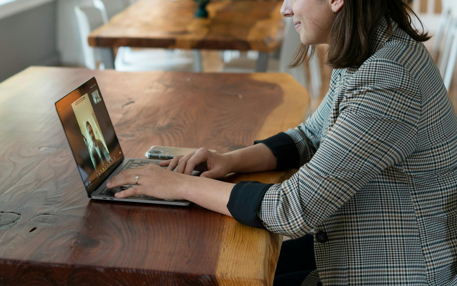 a woman sitting at a table using a laptop