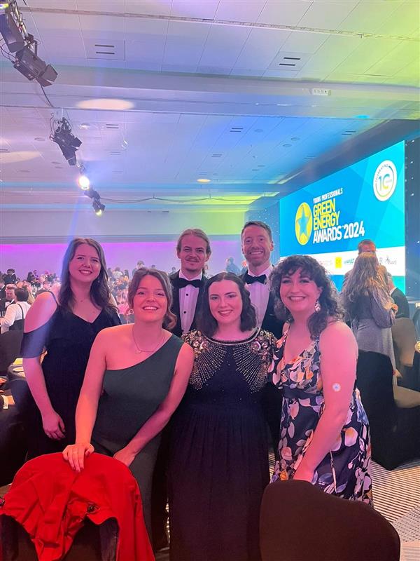 People posing for photo at awards ceremony