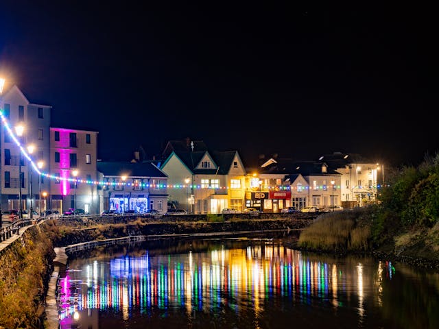Building lights reflecting on water front
