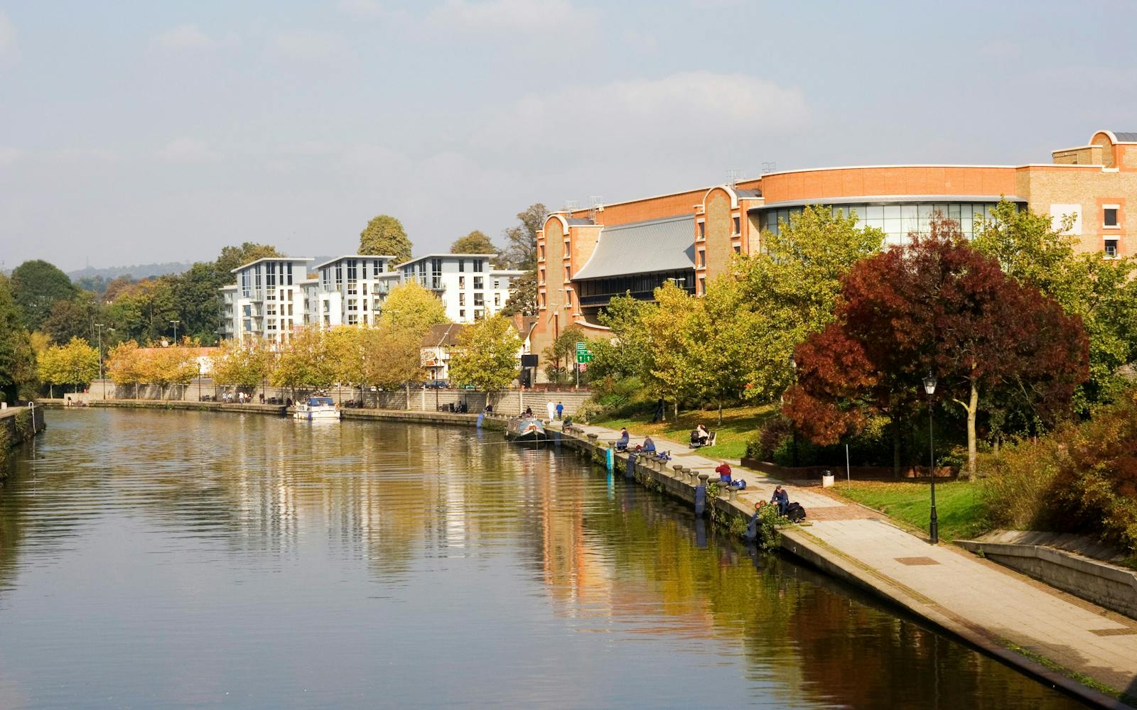 Large body of water, possibly a lake or river, next to a brick building on the Purdue University campus