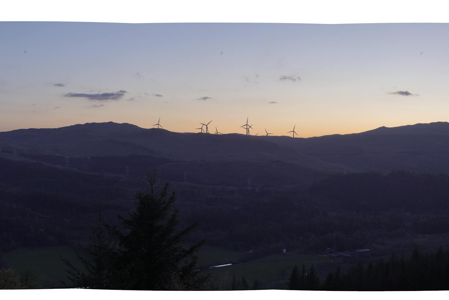 a dark horizon with wind turbines