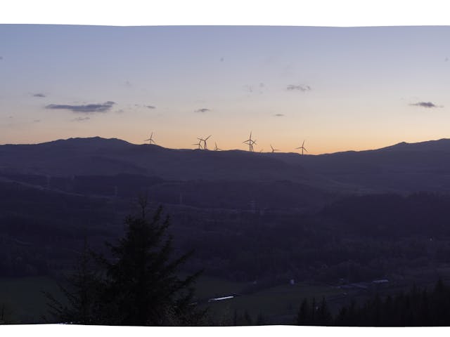a dark horizon with wind turbines