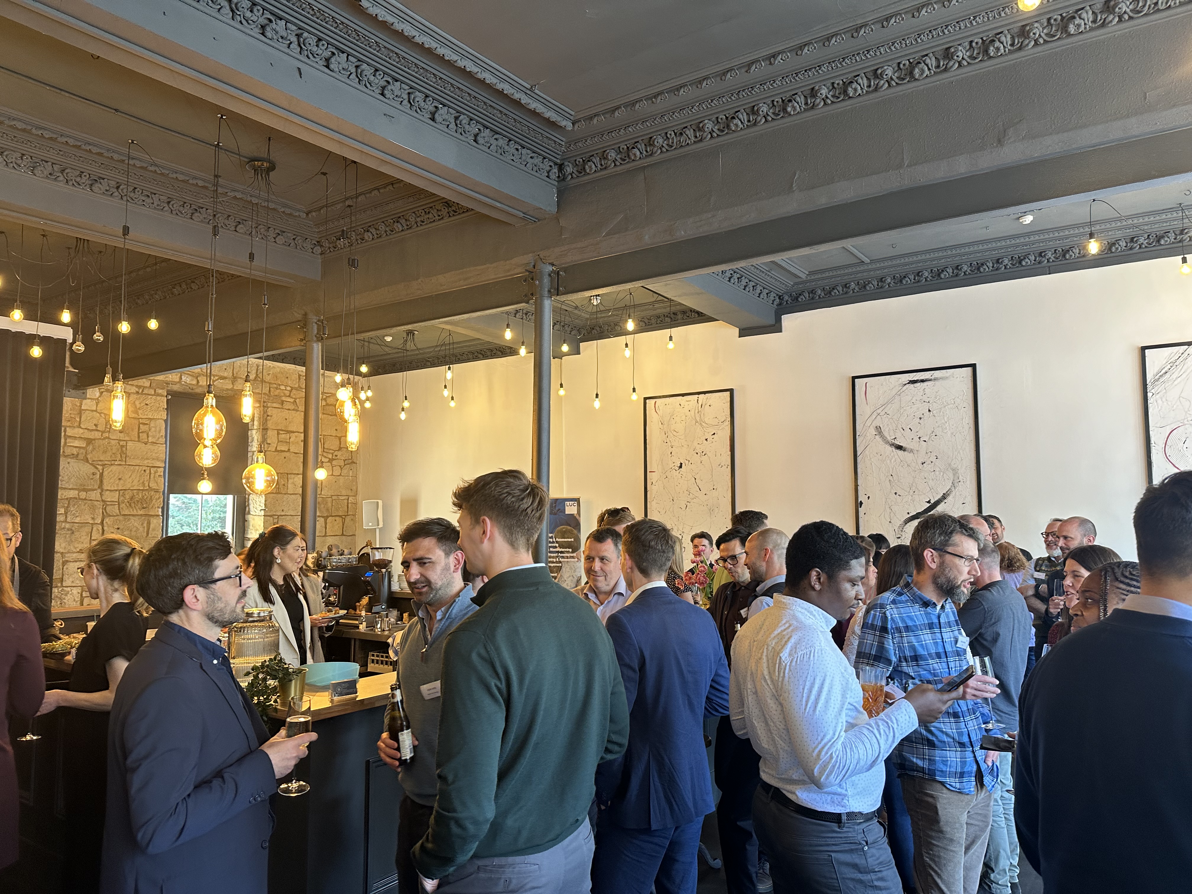 People standing in room having conversations