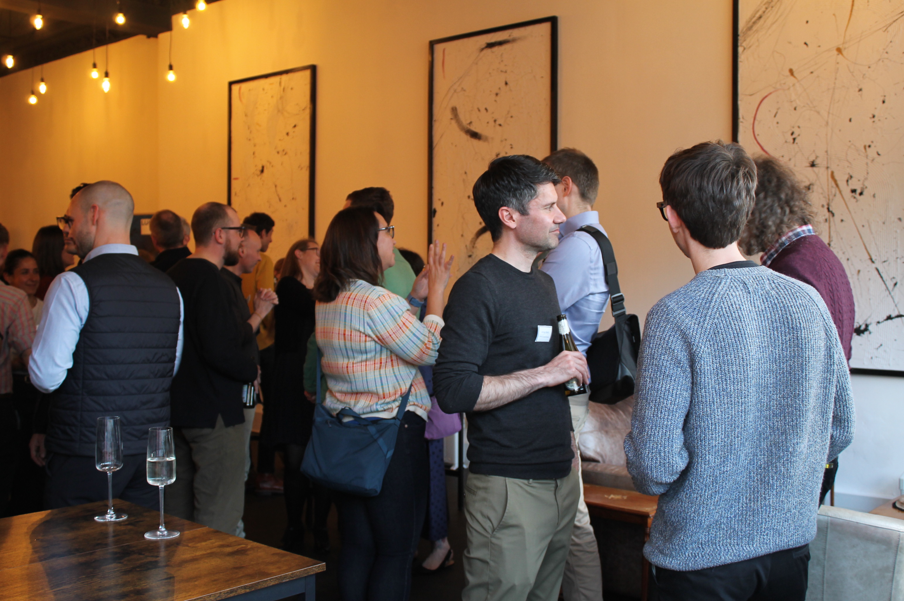 People standing in room having conversations