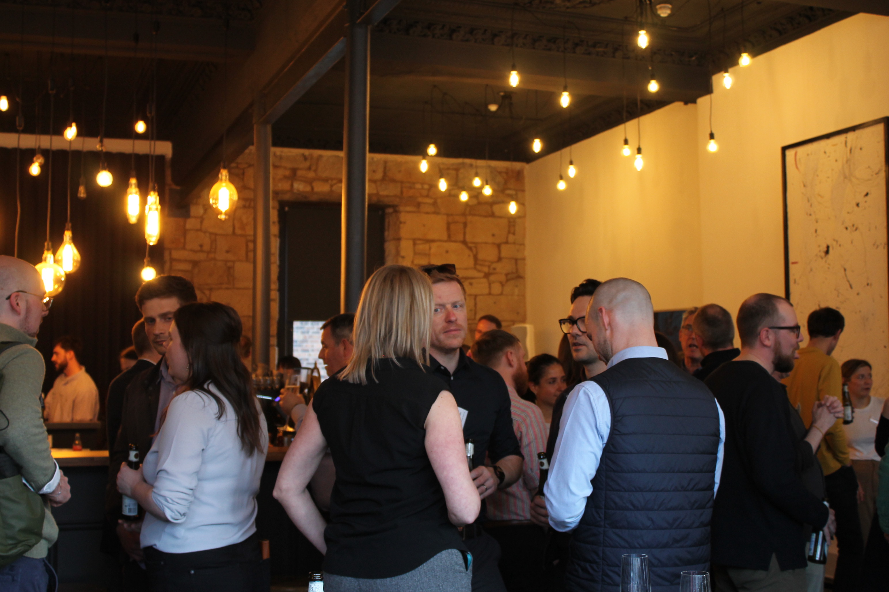 People standing in room having conversations