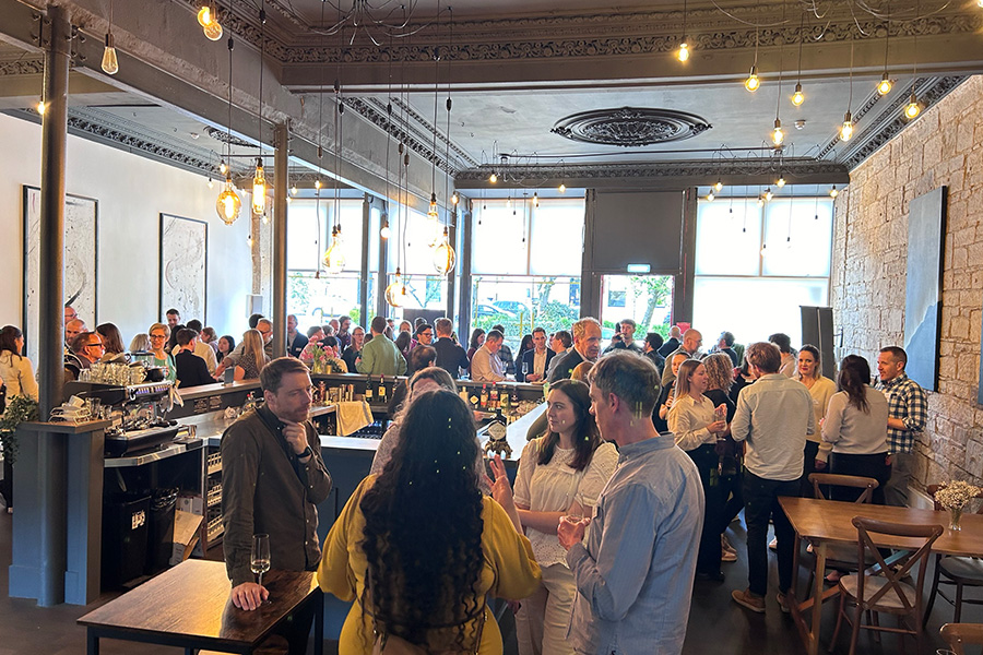 People standing in room having conversations