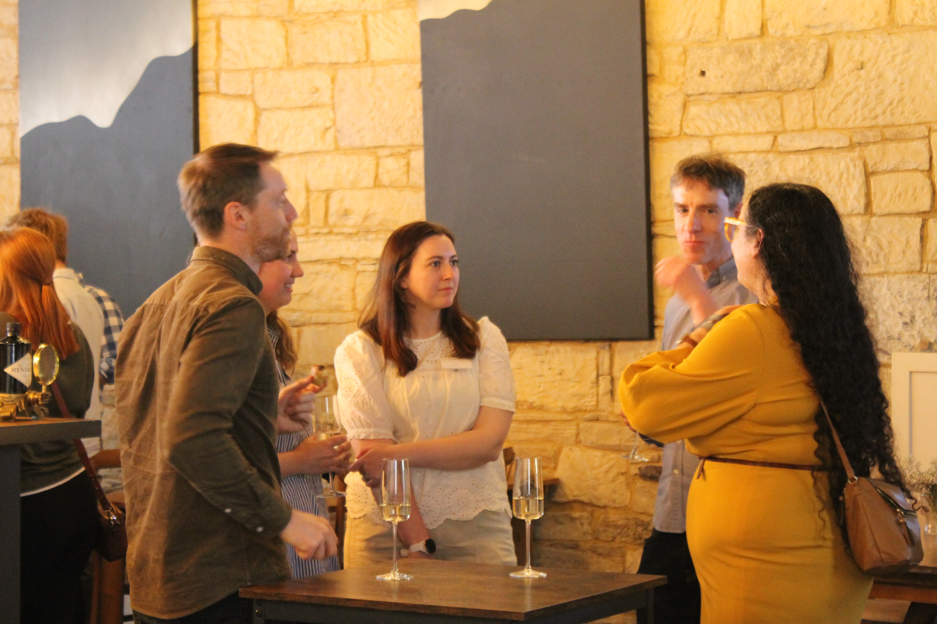 People standing in room having conversations