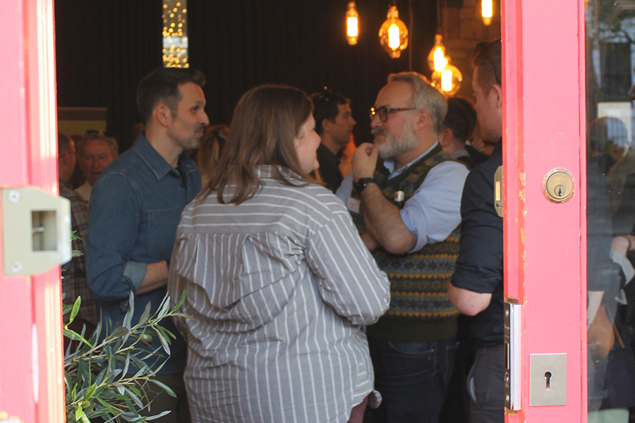 People standing in room having conversations