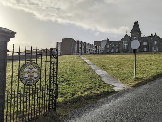 Image looking onto school building from entrance gate