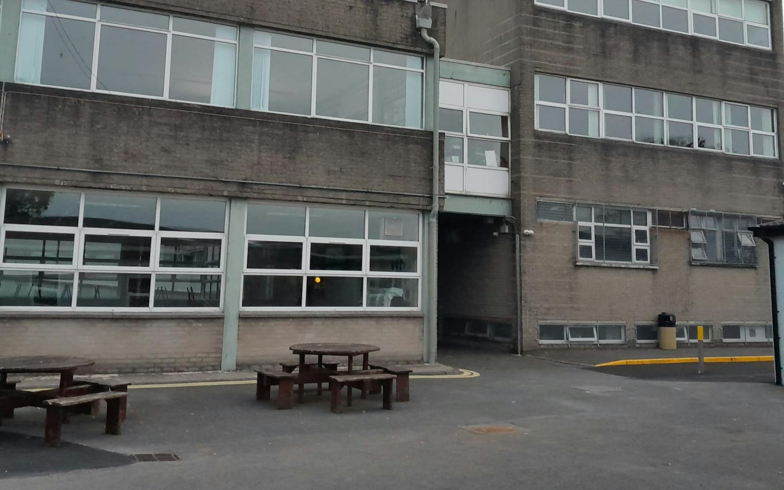 a building with benches and tables outside