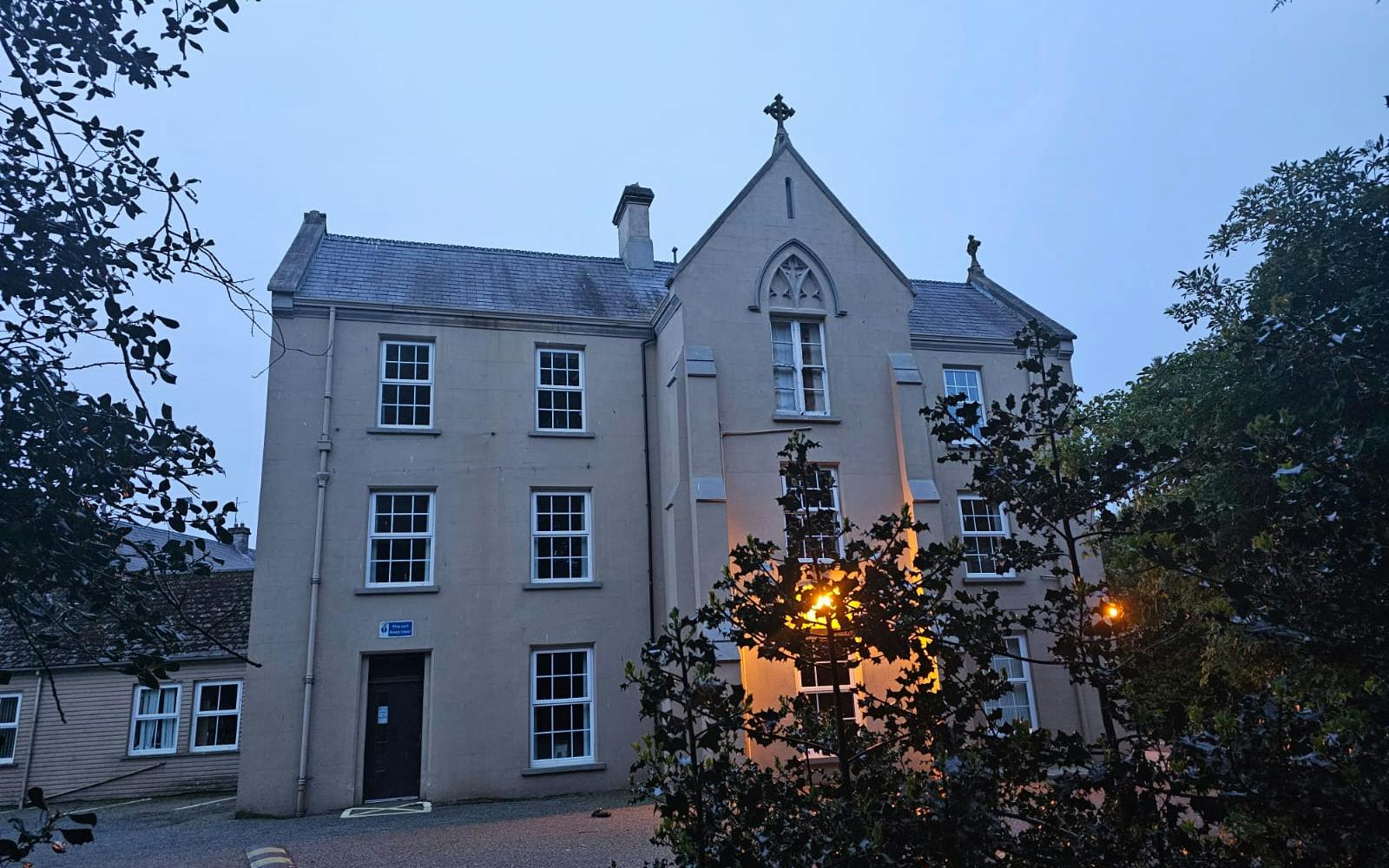 a building with trees and street light