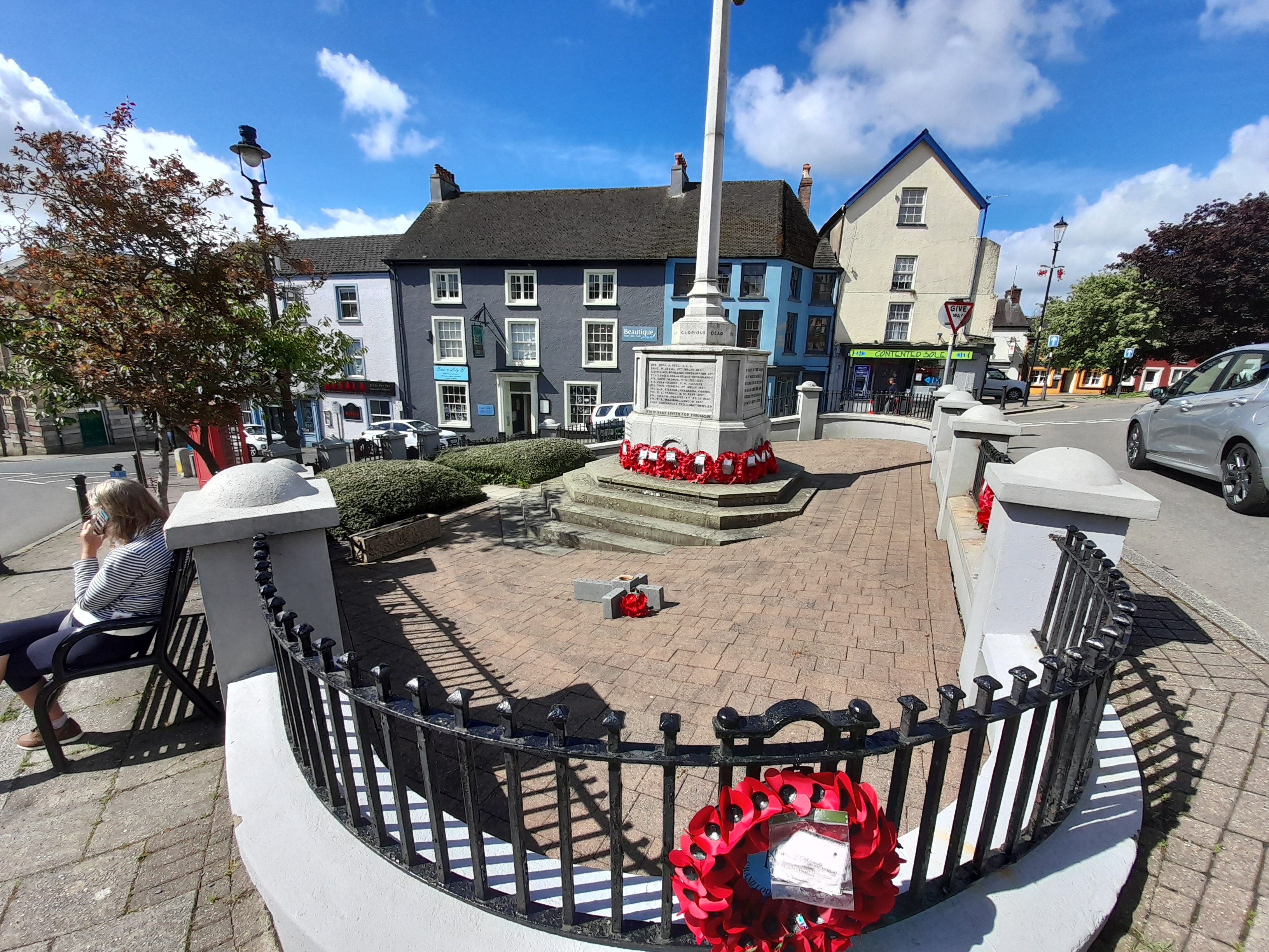 a monument with a flag in the middle of a town