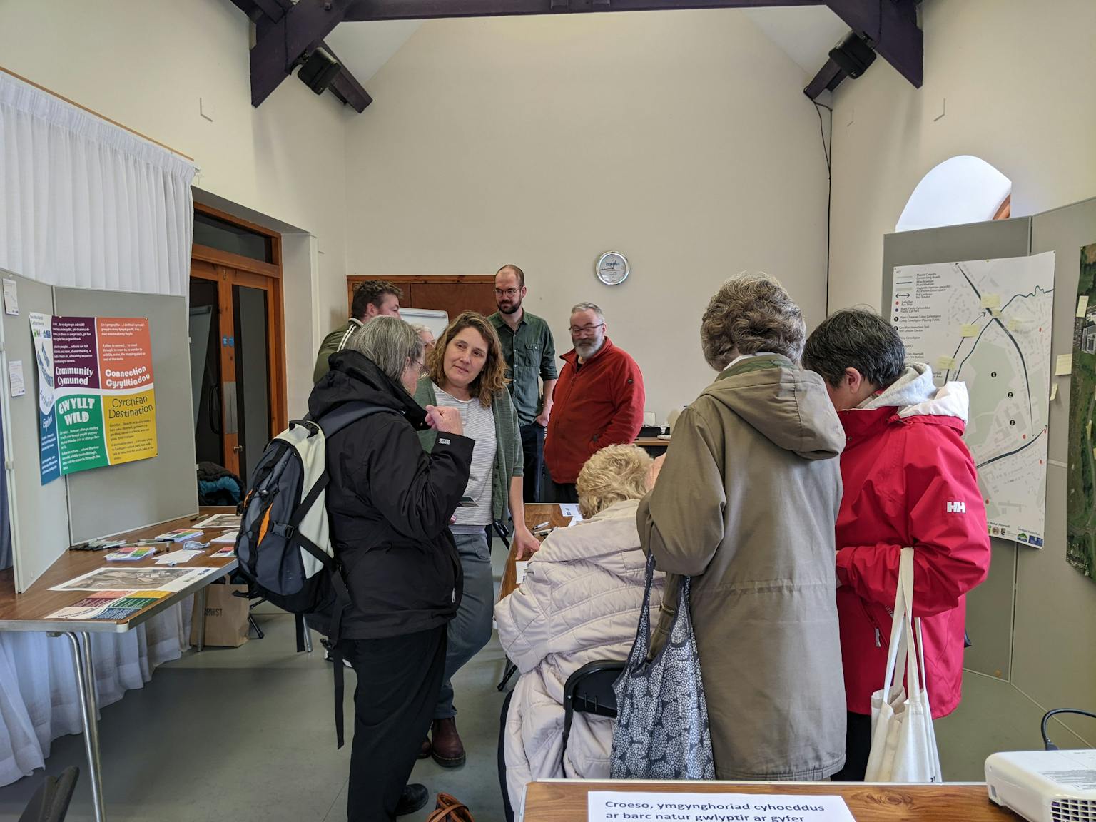 a group of people talking about a table