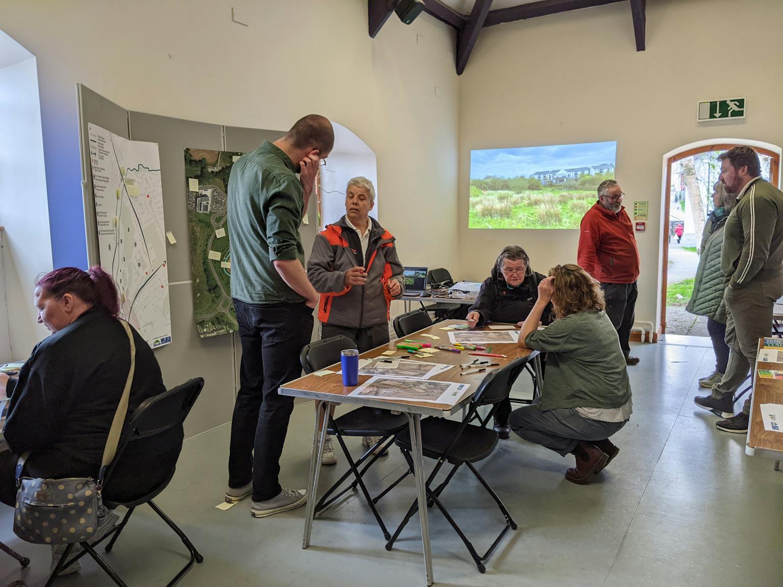 a group of people talking about a table