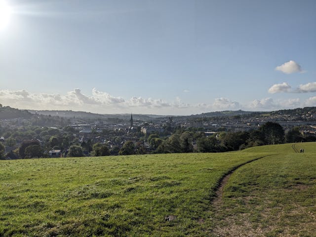 A field with a city in the background