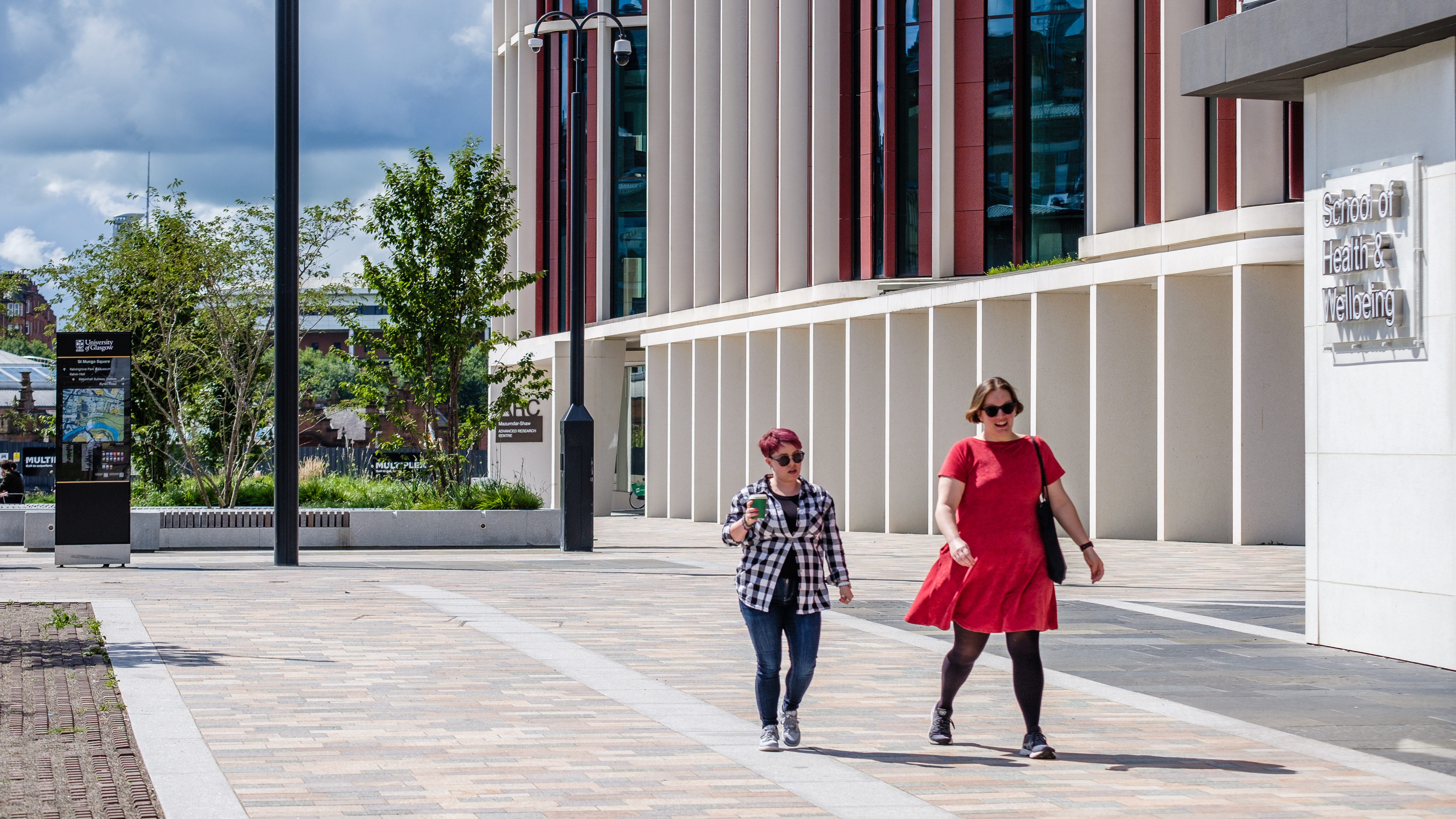 two women walking on a brick walkway