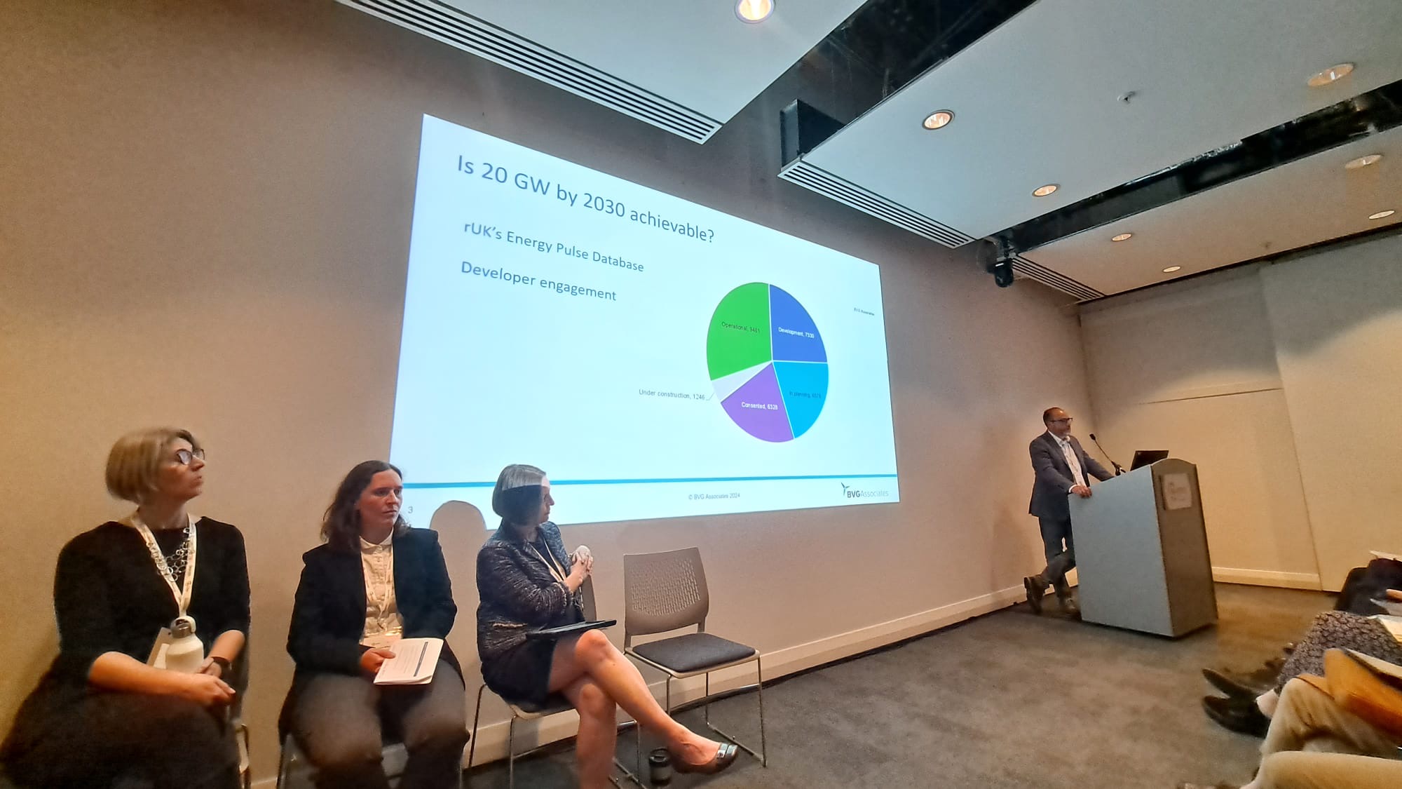 Person delivering a presentation with panel