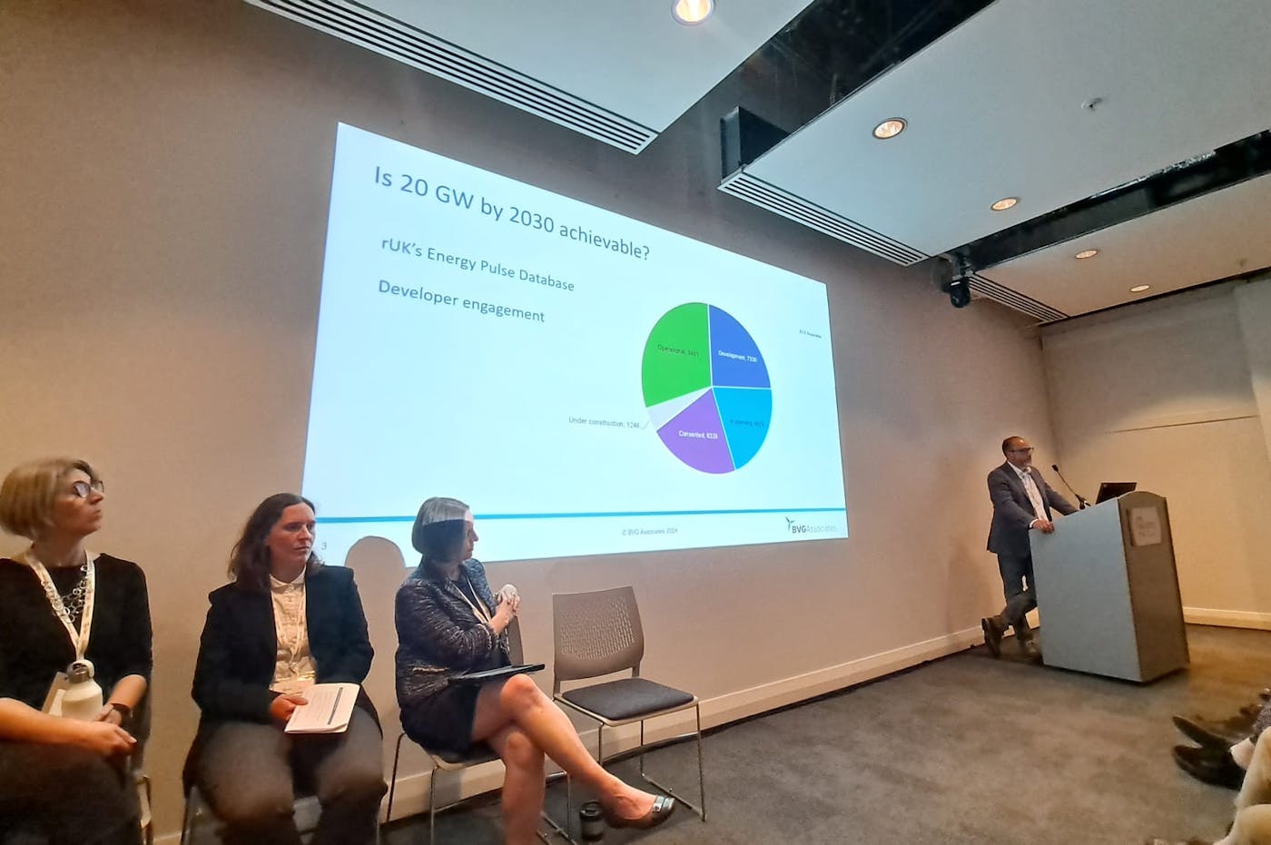 Person delivering a presentation with panel